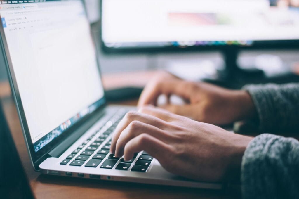 funnel experience with hands typing on laptop keyboard